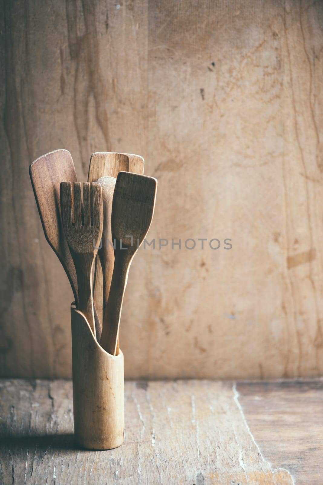 Kitchen utensiles on wooden table. Retro filter.