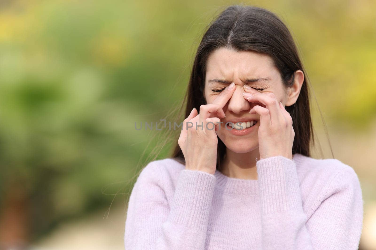 Teen scratching itchy eyes complaining outdoors in a park