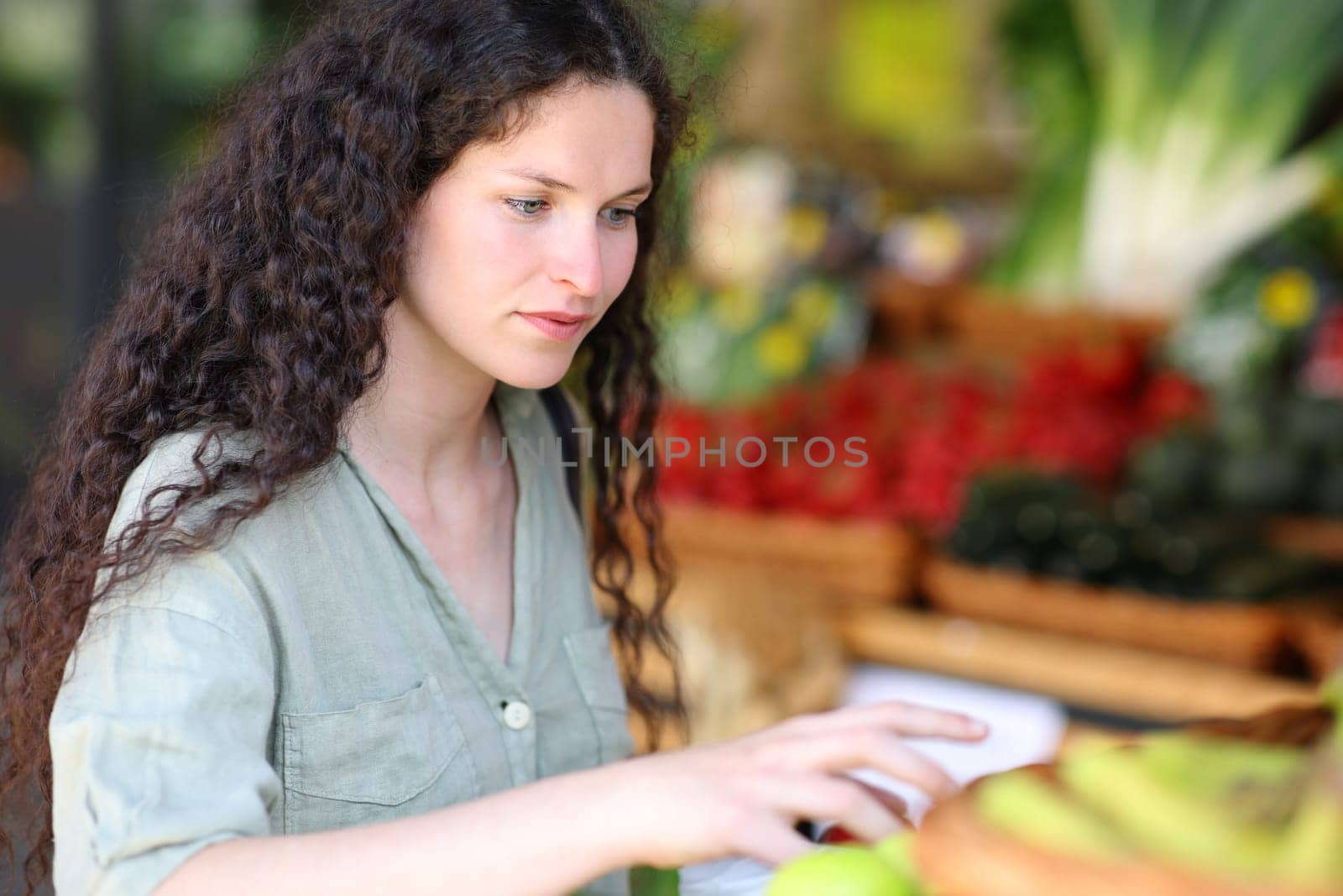 Satisfied client ready to catch vegetables in a greengrocery