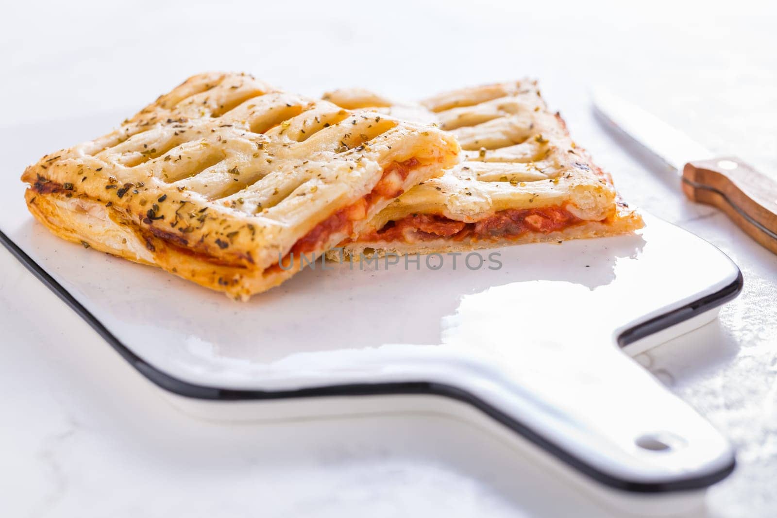 Puff pastry vegetable pie with tomatoes, onions, herbs and eggplant