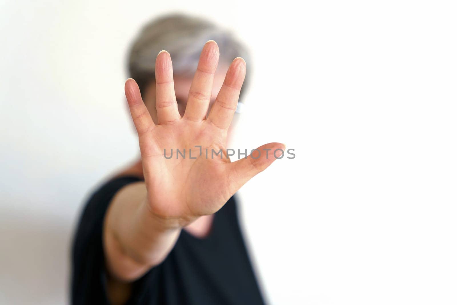 A woman protects herself with defensive hand movement