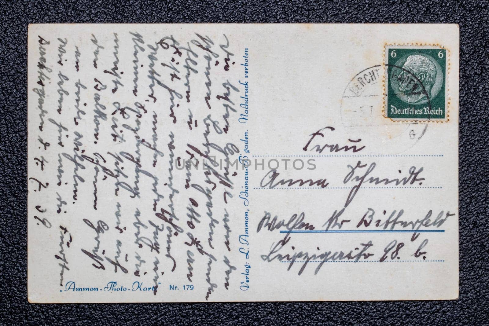 Potsdam, Germany - MAY 06, 2022. A old postcards from 1939 with stamp showing the portrait of the German Reich President Paul von Hindenburg, Germany, Third Reich. Black background.