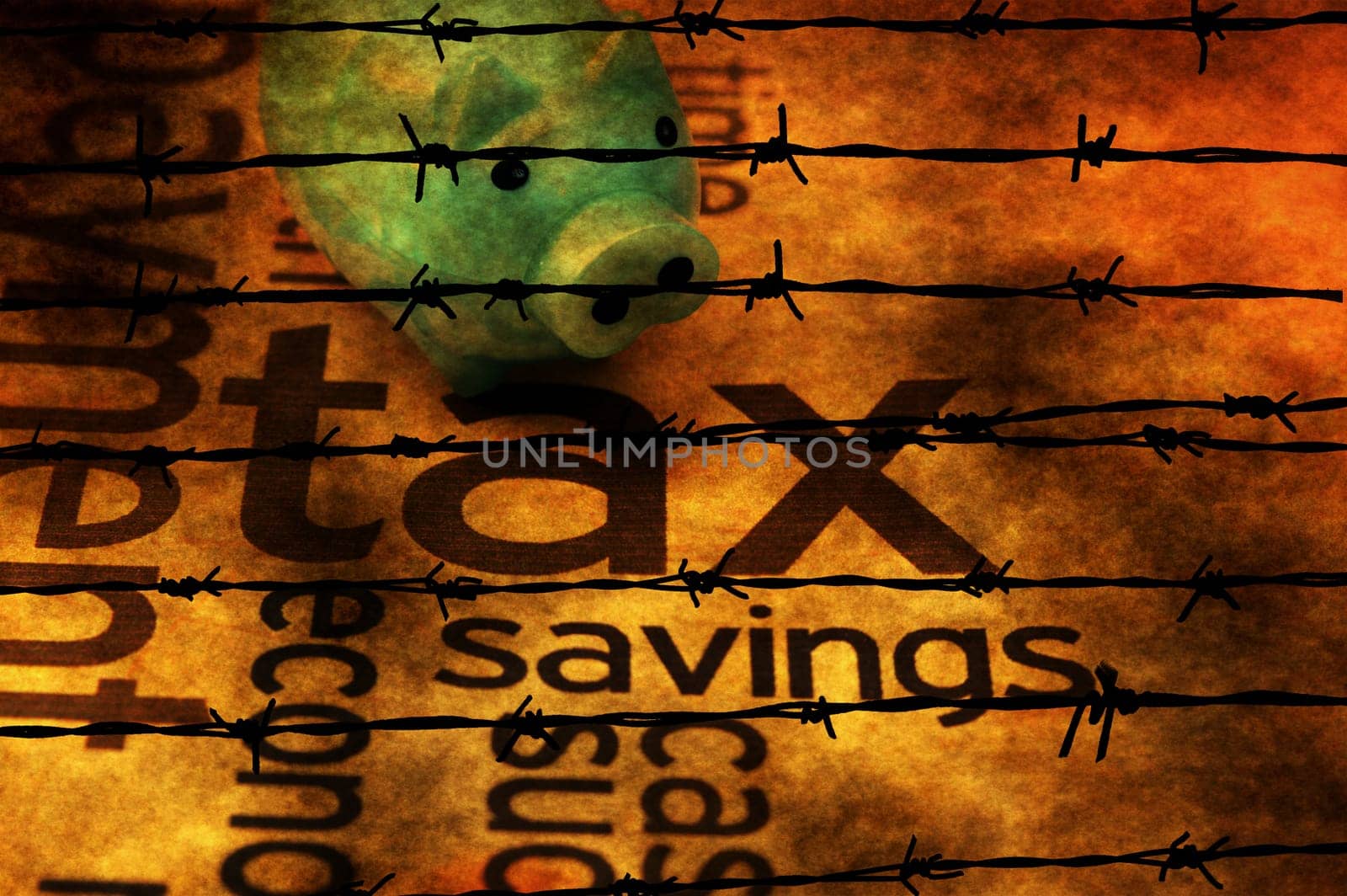 Piggy bank and tax concept against barbwire