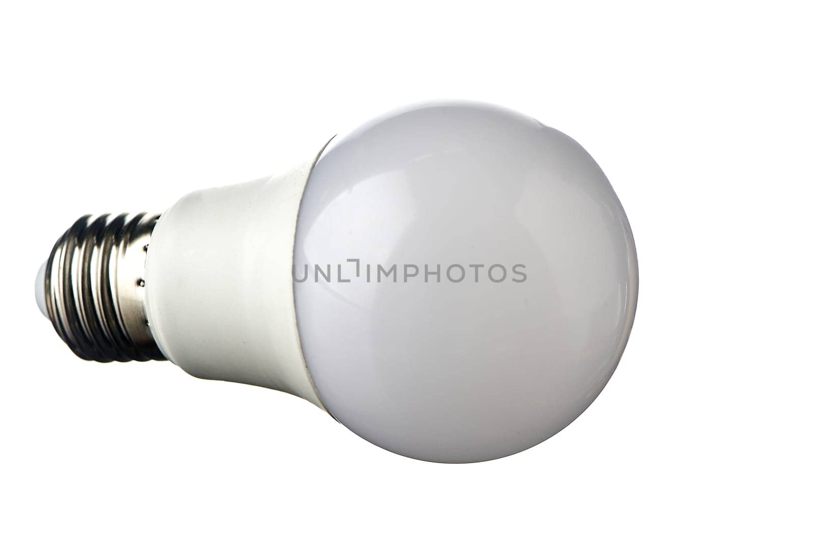 A white LED lamp with an E27 base lies on a white insulated background. High quality photo