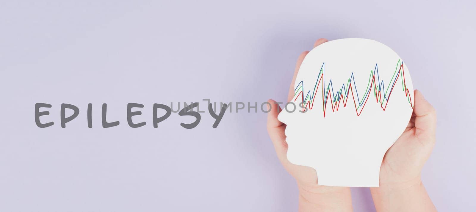 Holding a head in the hands, epilepsy disorder awareness, brain waves,mental health care, paper cut out, purple color