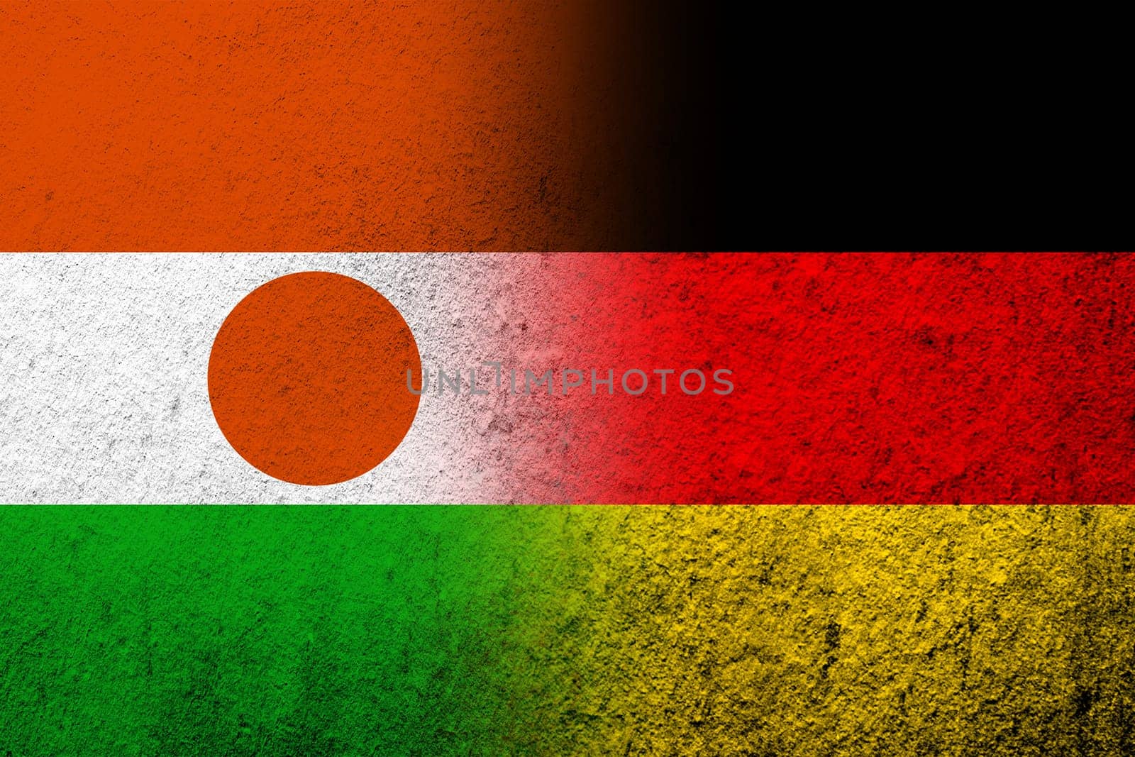 The national flag of Germany with The Republic of the Niger National flag. Grunge background