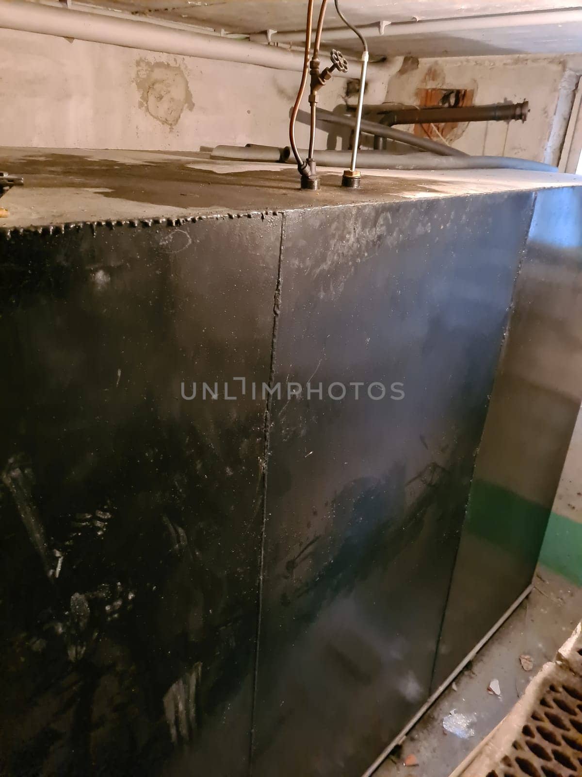 Old heating oil tank in dingy dank basement.
