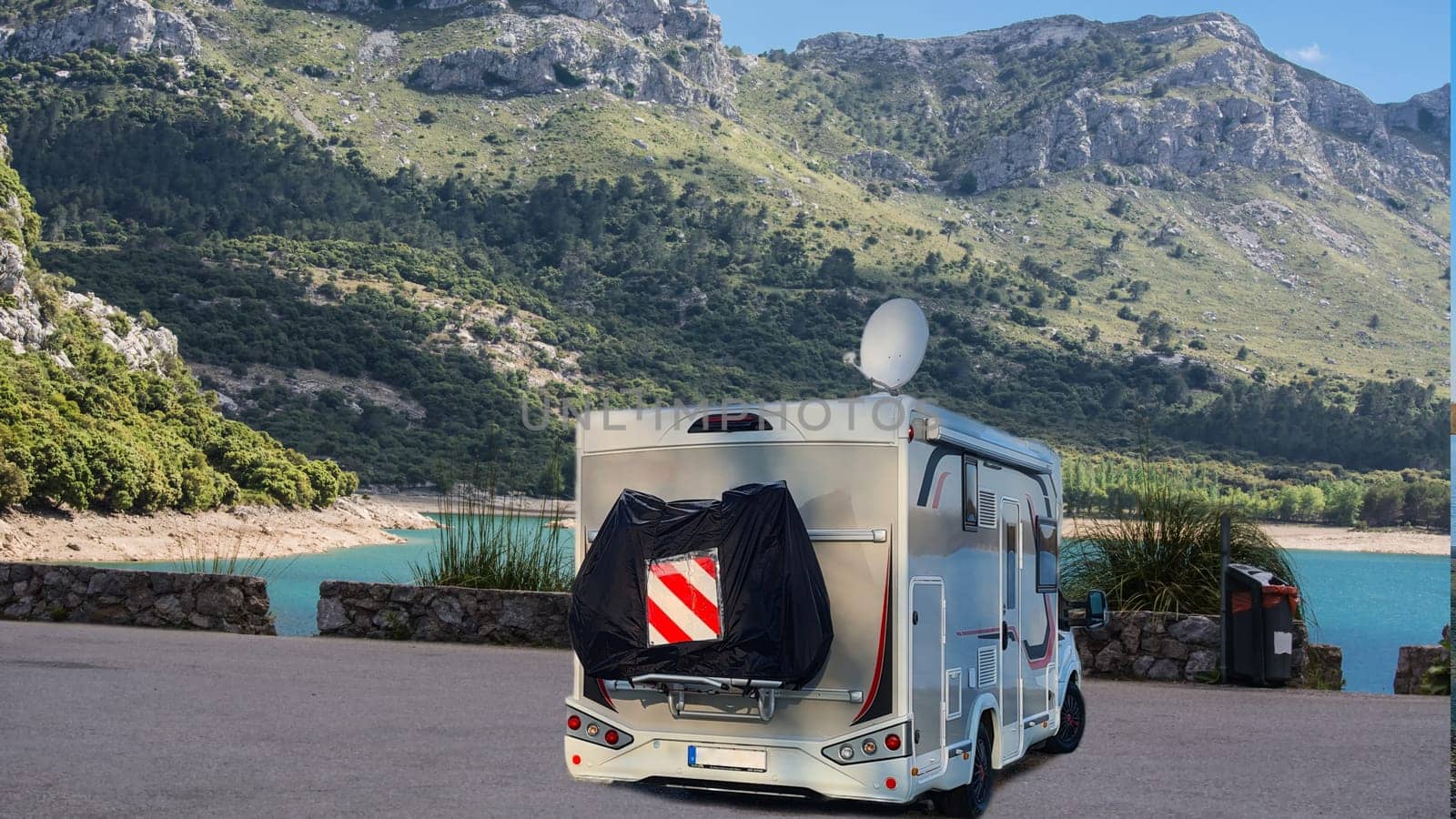 Motorhome campervan parked in a parking lot in Mallorca with the freshwater reservoirs, Embalse de Cúber and the Gorg Blau in the background