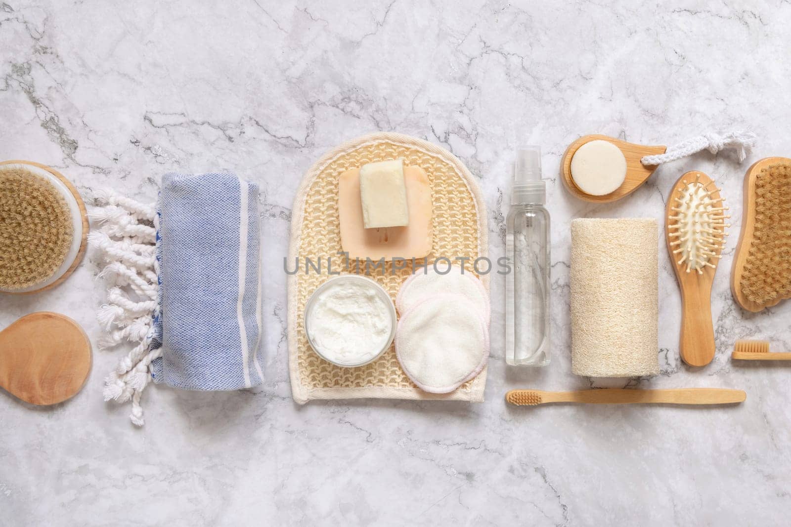 Organic natural cosmetics and zero waste reusable accessories for skin and hair care on marble flat lay. Top view of eco friendly beauty products for bath, massage or spa salon