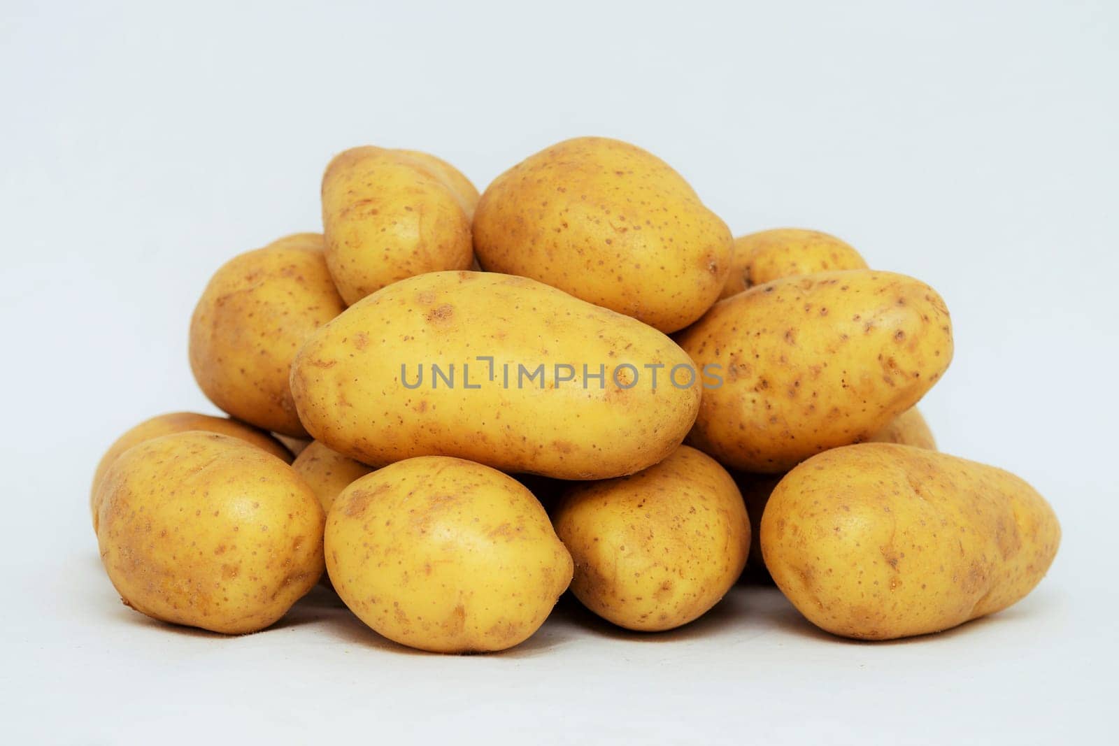 Fresh organic potatoes on white background