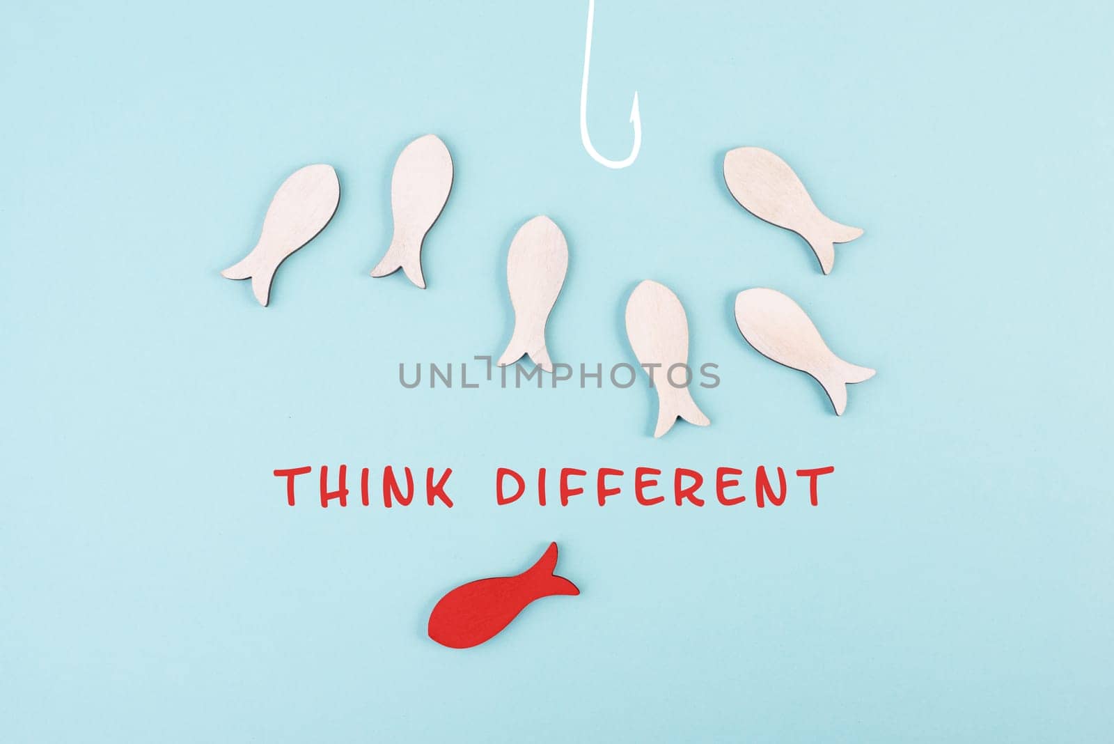 Group of fishes swimming to the fishing rod, red fish thinks different and takes the opposite direction, against the stream symbolic, courage and winner concept