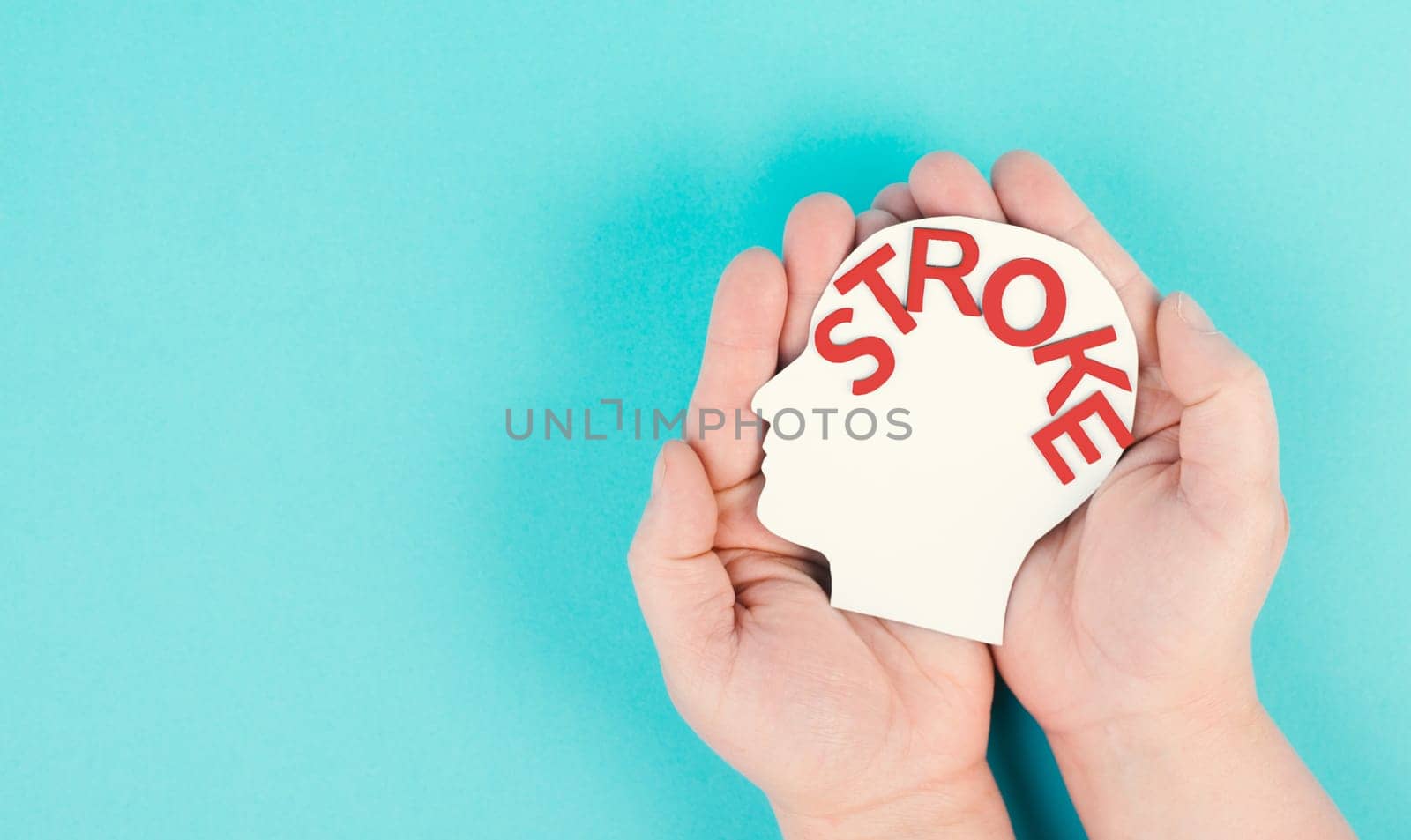 Holding a head with the word stroke in the hand, brain injury, ischemic and hemorrhagic types, health care