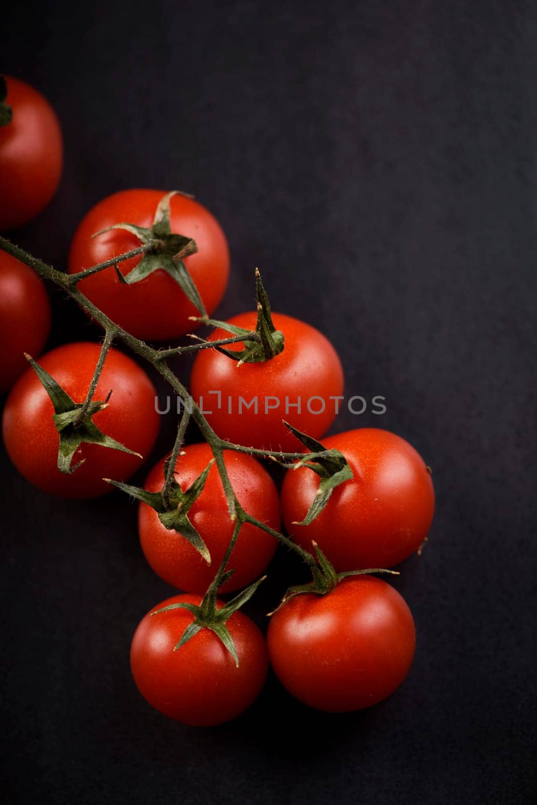 Cherry tomato on rustic black background