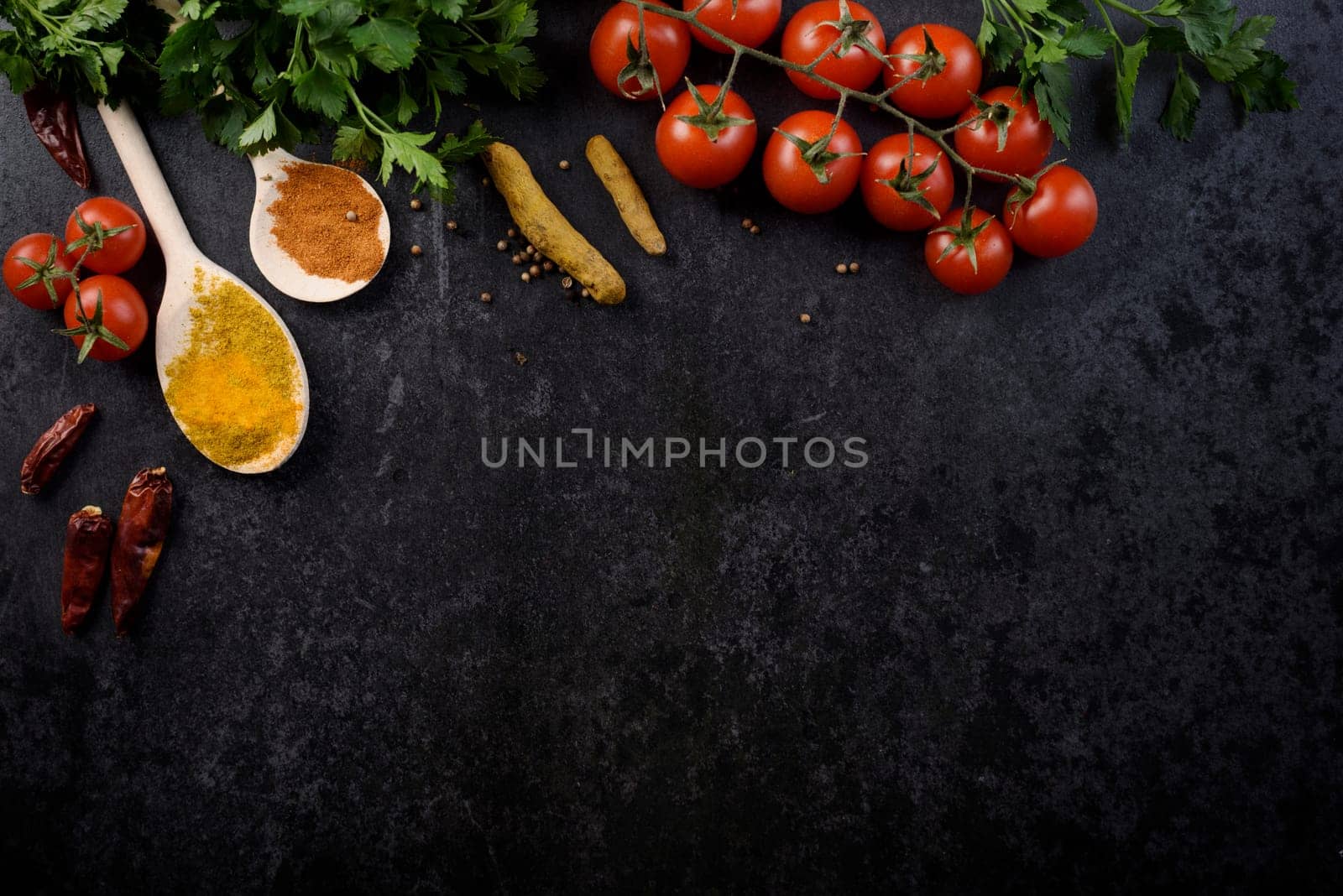 Food ingredients and various spices on black rustic background