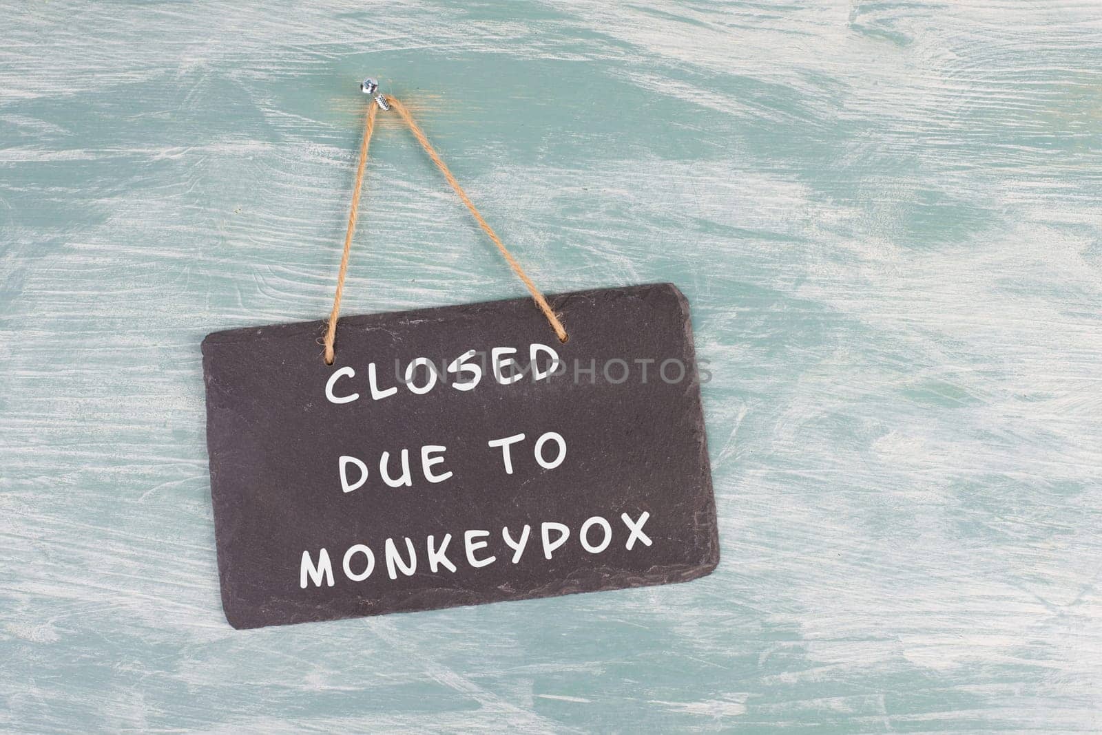 The words closed due to monkeypox are standing on a sign, outbreak of the MPXV virus pandemic, infectious disease spreading