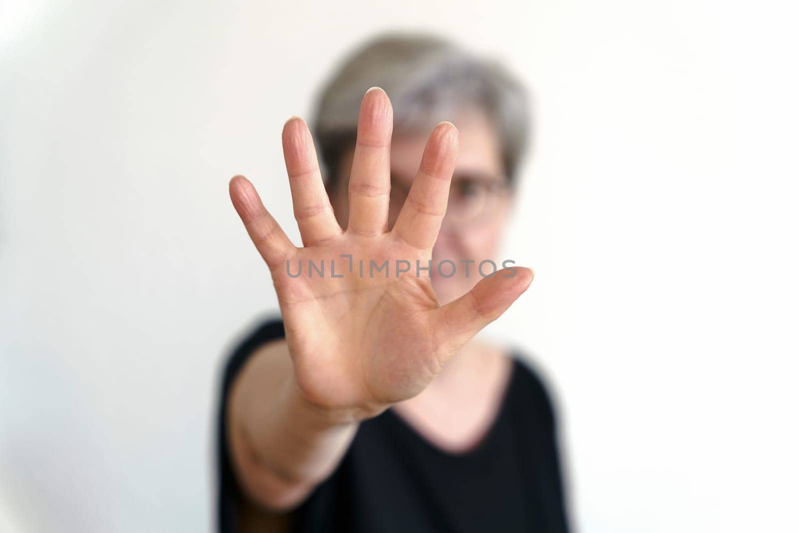 An adult woman protects herself with defensive hand movement