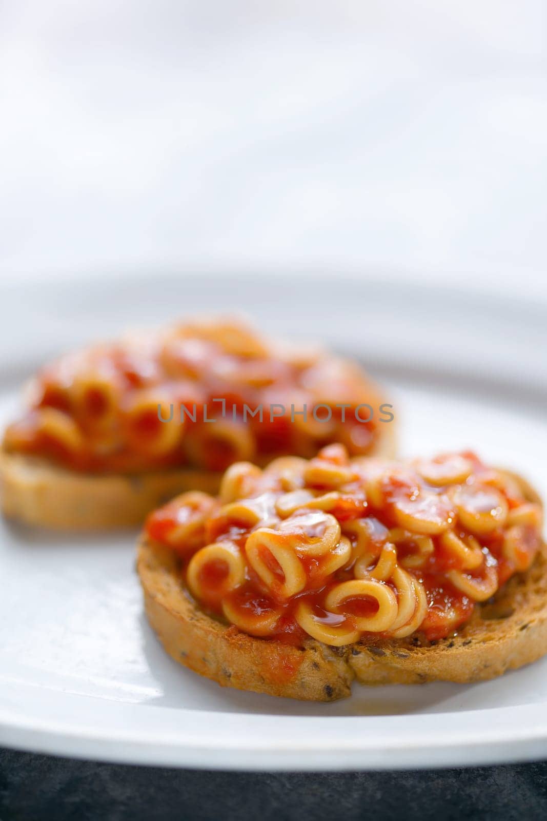 close up of english aussie pasta hoops in tomato sauce toast comfort food
