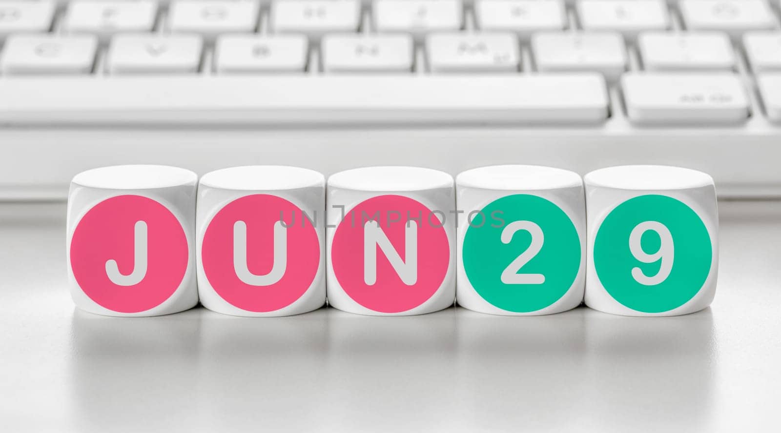 Letter dice in front of a keyboard - June 29