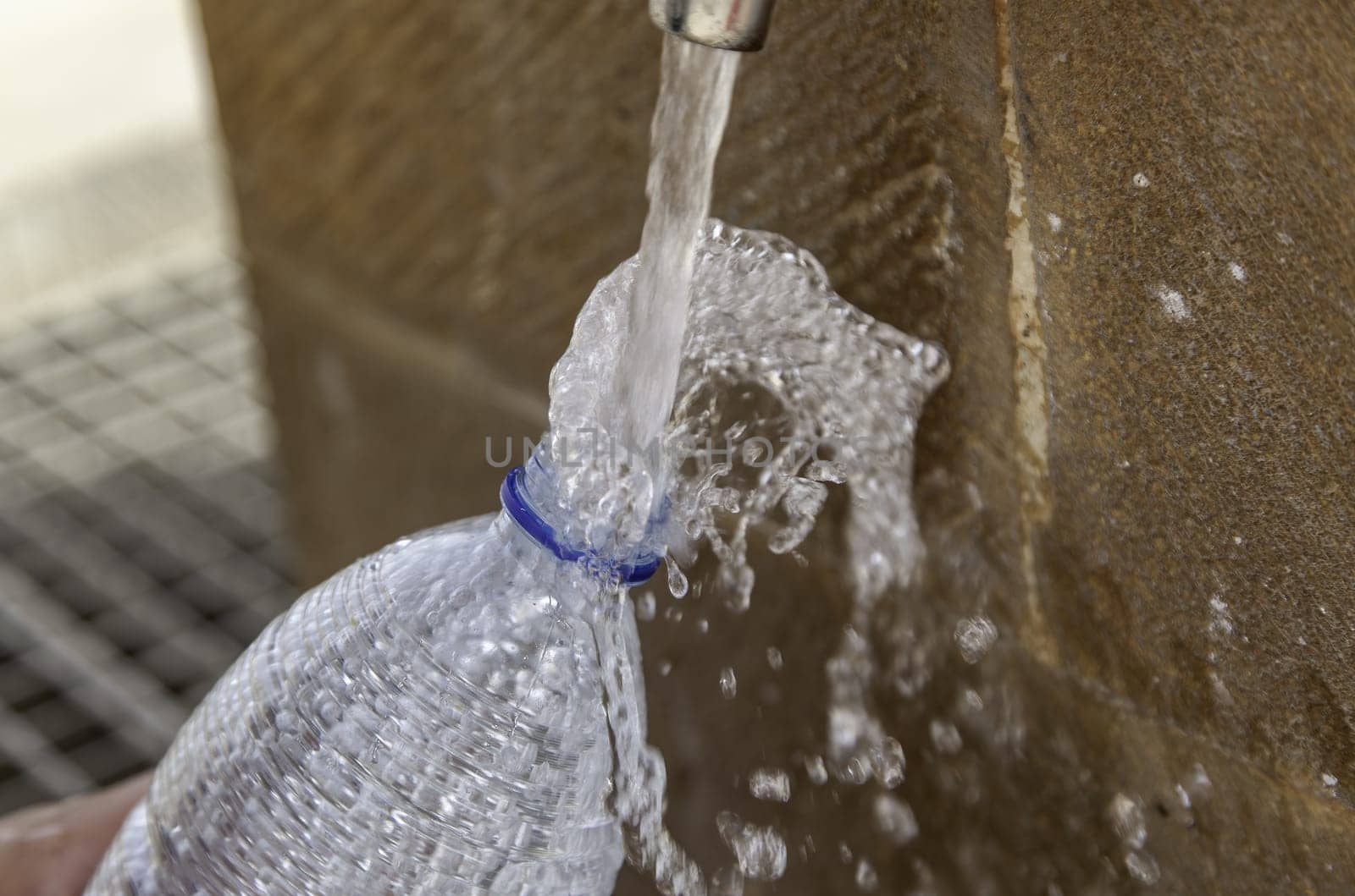 Filling water bottle in fountain, water and summer, refreshment