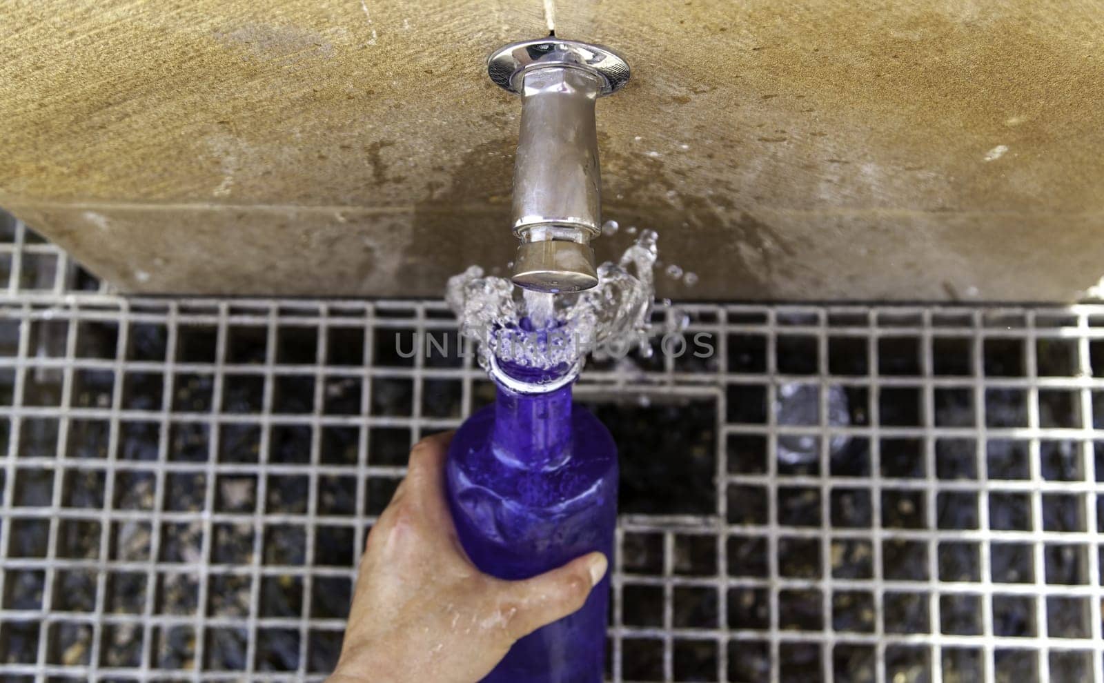 Filling water bottle in fountain, water and summer, refreshment