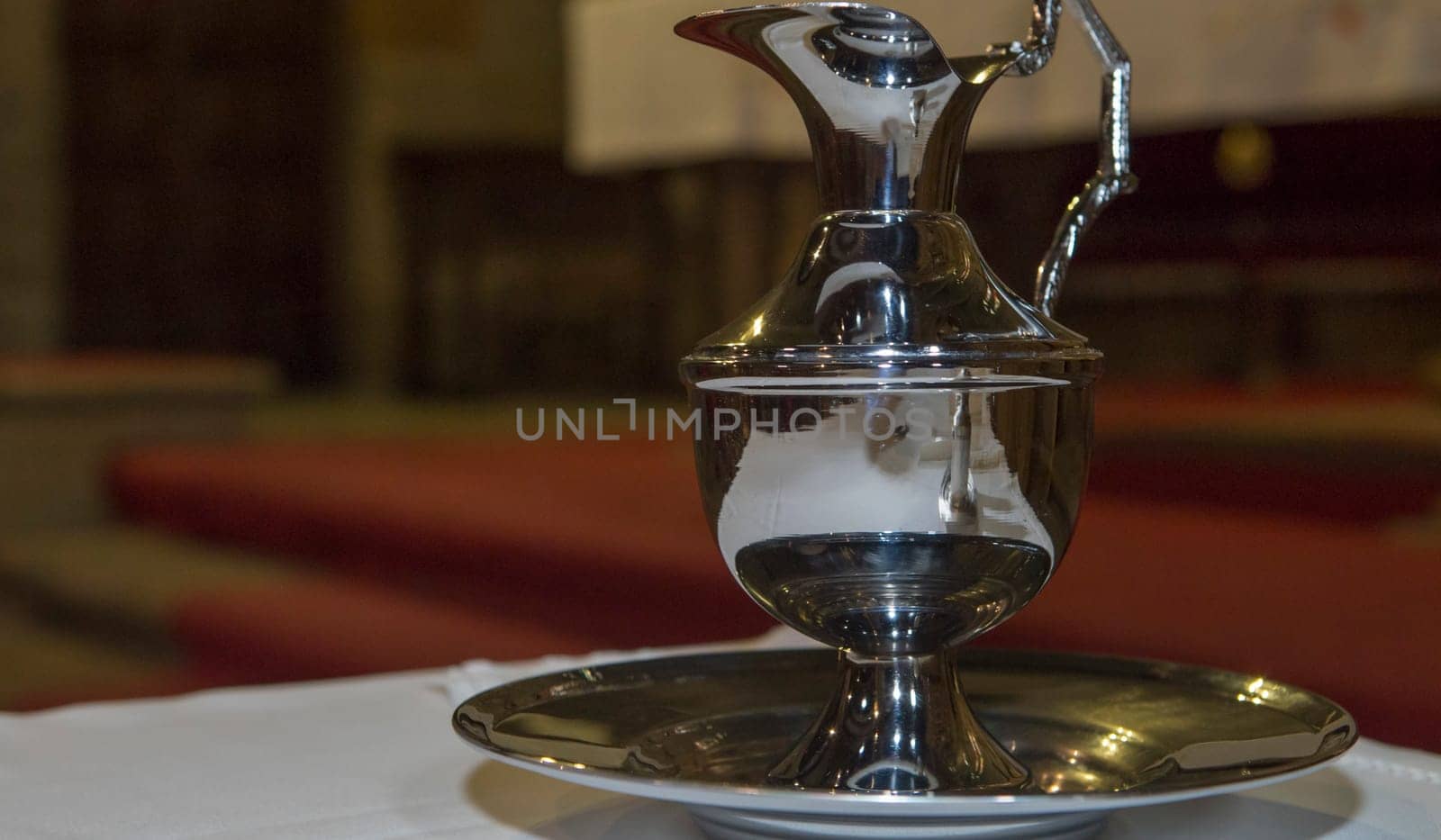 Plasencia, Spain - May 21h, 2022: Liturgical wash basin and pitcher over Saint Nicholas Church altar, Plasencia, Caceres, Extremadura, Spain
