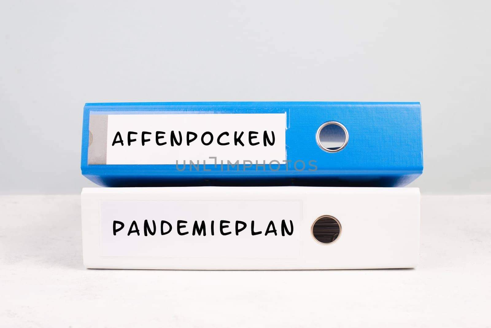 The words monkeypox and pandemic plan are standing in german language on a folder, outbreak of the MPXV virus, infectious disease spreading