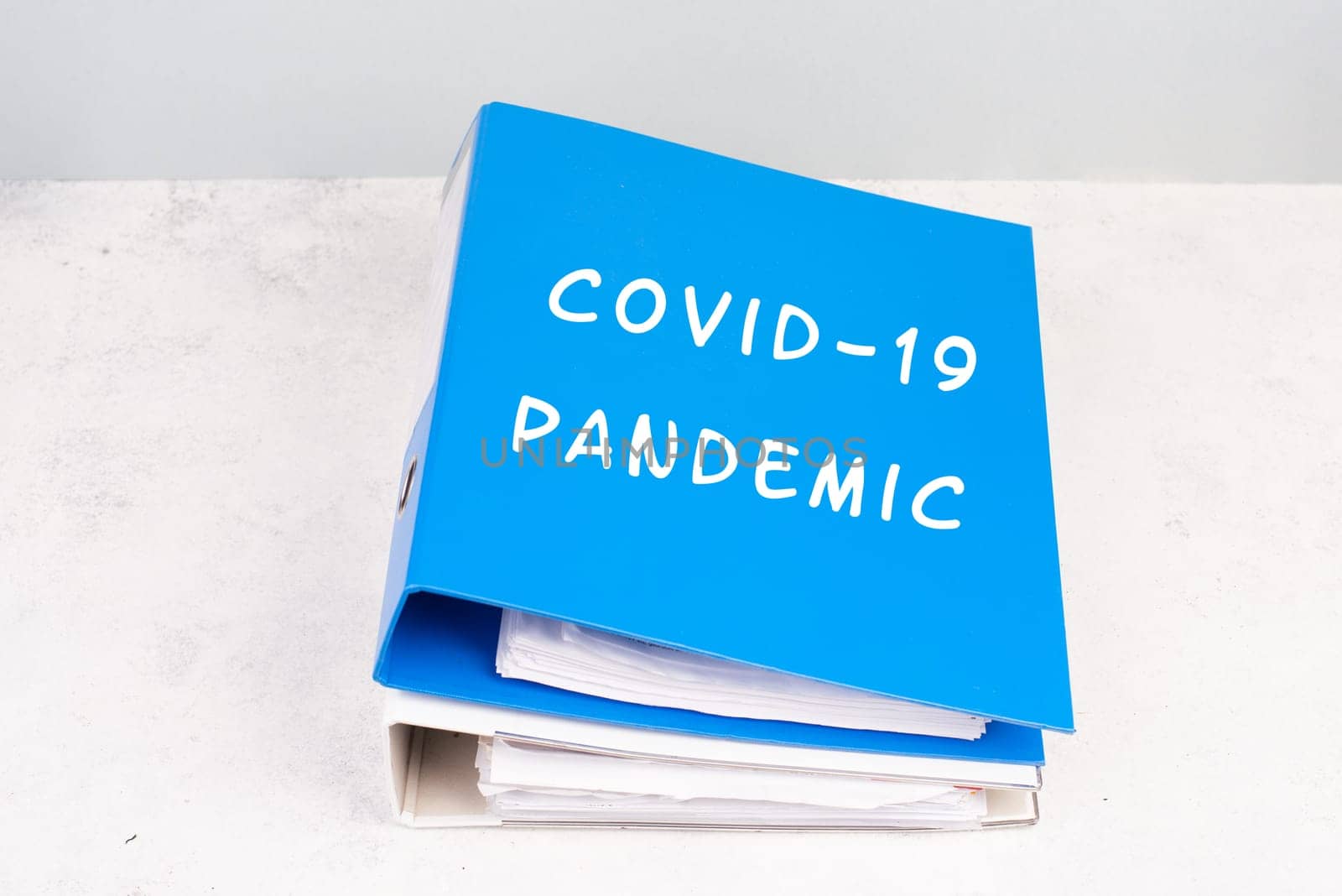 The words Covid-19 pandemic are standing on a folder, outbreak of virus infectious disease, processing of the regualtions, documents for evidence