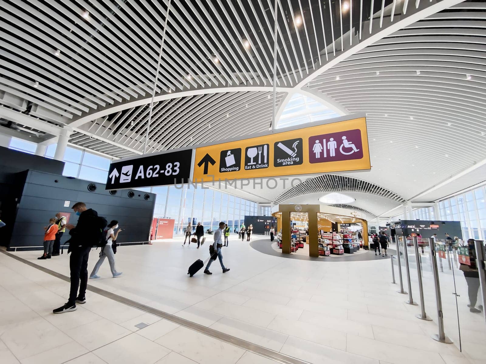 Rome, Italy, May 2022: People walking in the new departure hall of Leonardo Da Vinci Airport in Fiumicino, Rome