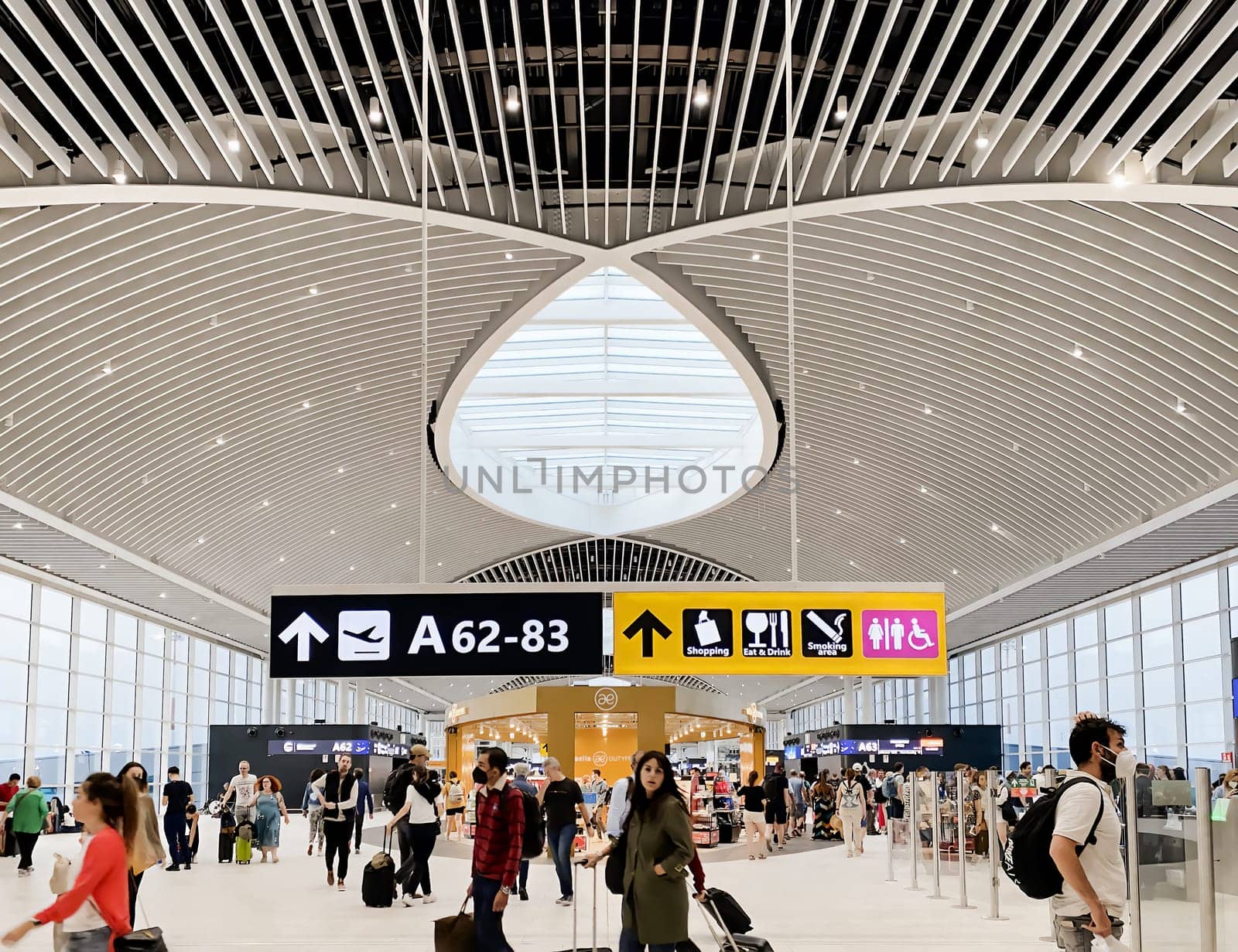 Rome, Italy, May 2022: People walking in the new departure hall of Leonardo Da Vinci Airport in Fiumicino, Rome