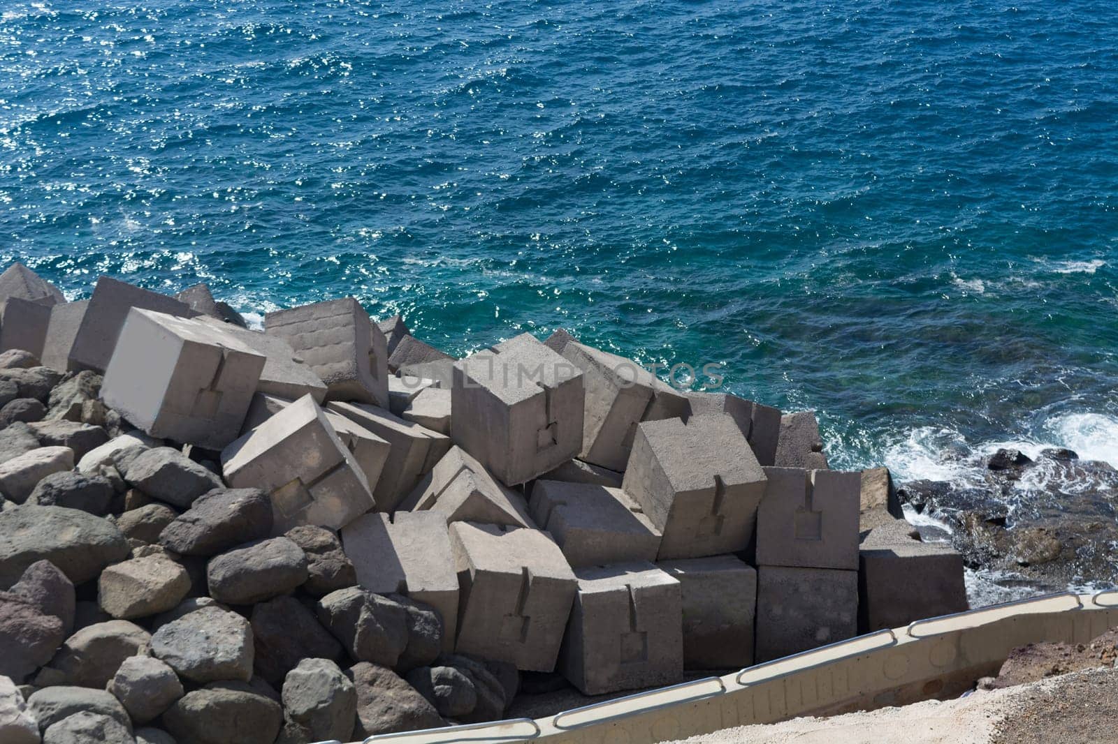 View of concrete breakwater from in a rock in Puerto Rico, Gran Canaria