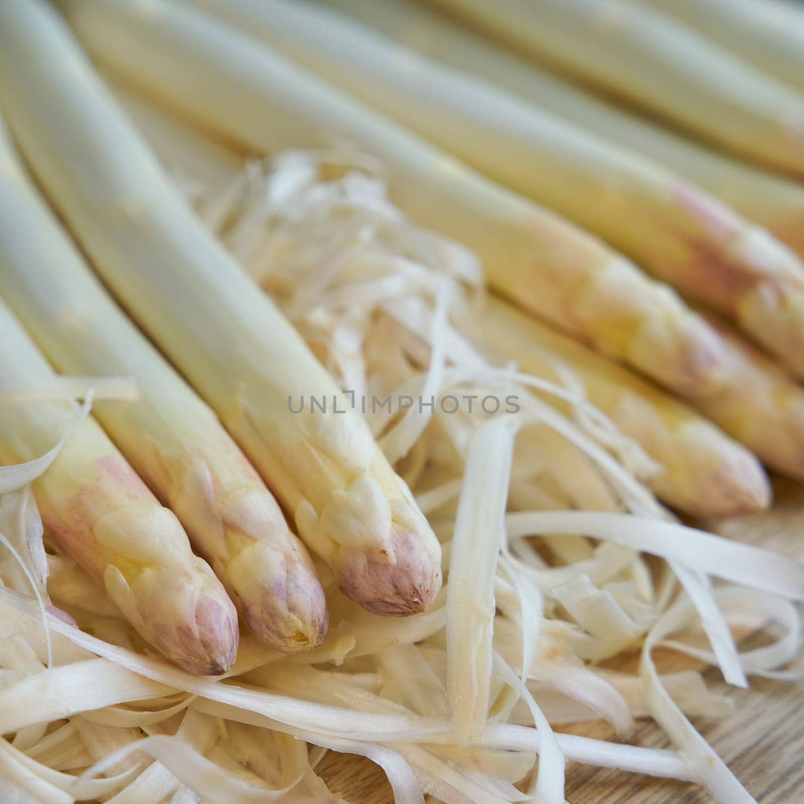 Peeled white asparagus on a kitchen table