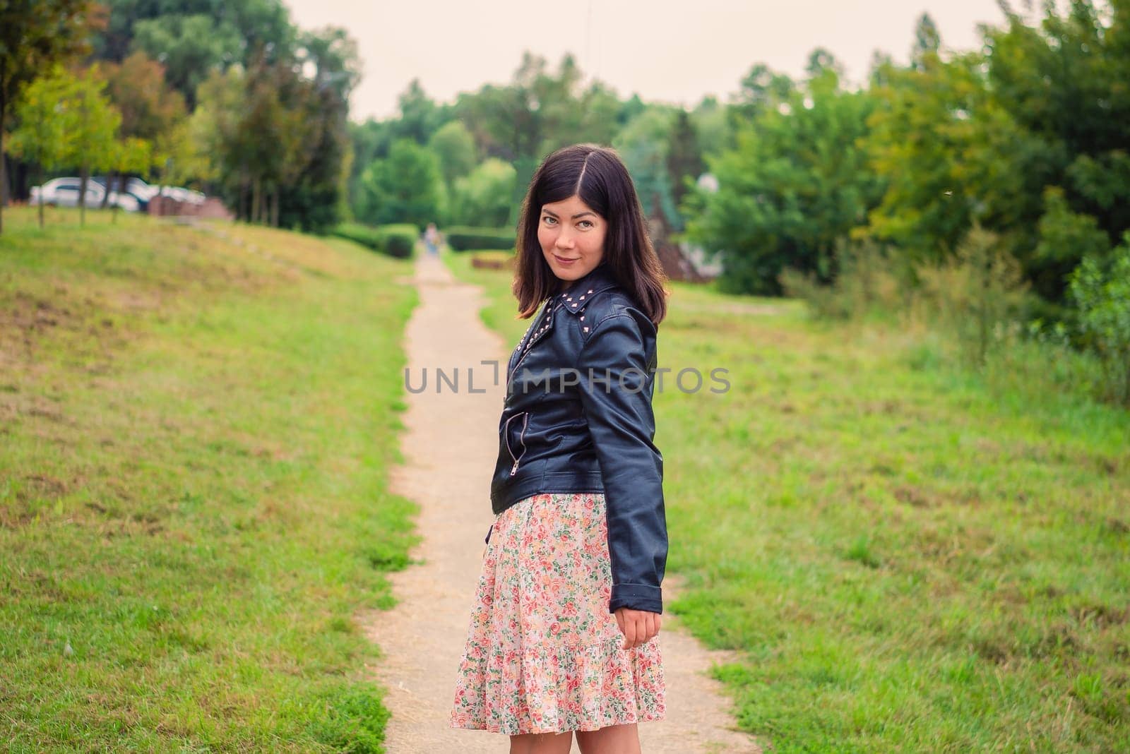 portrait of a young black-haired girl in the park