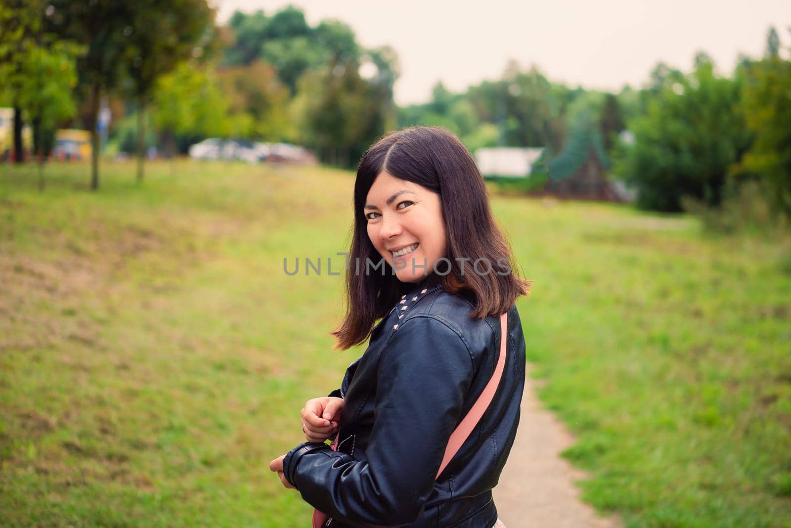 Portrait from the back of a smiling cheerful young brunette girl