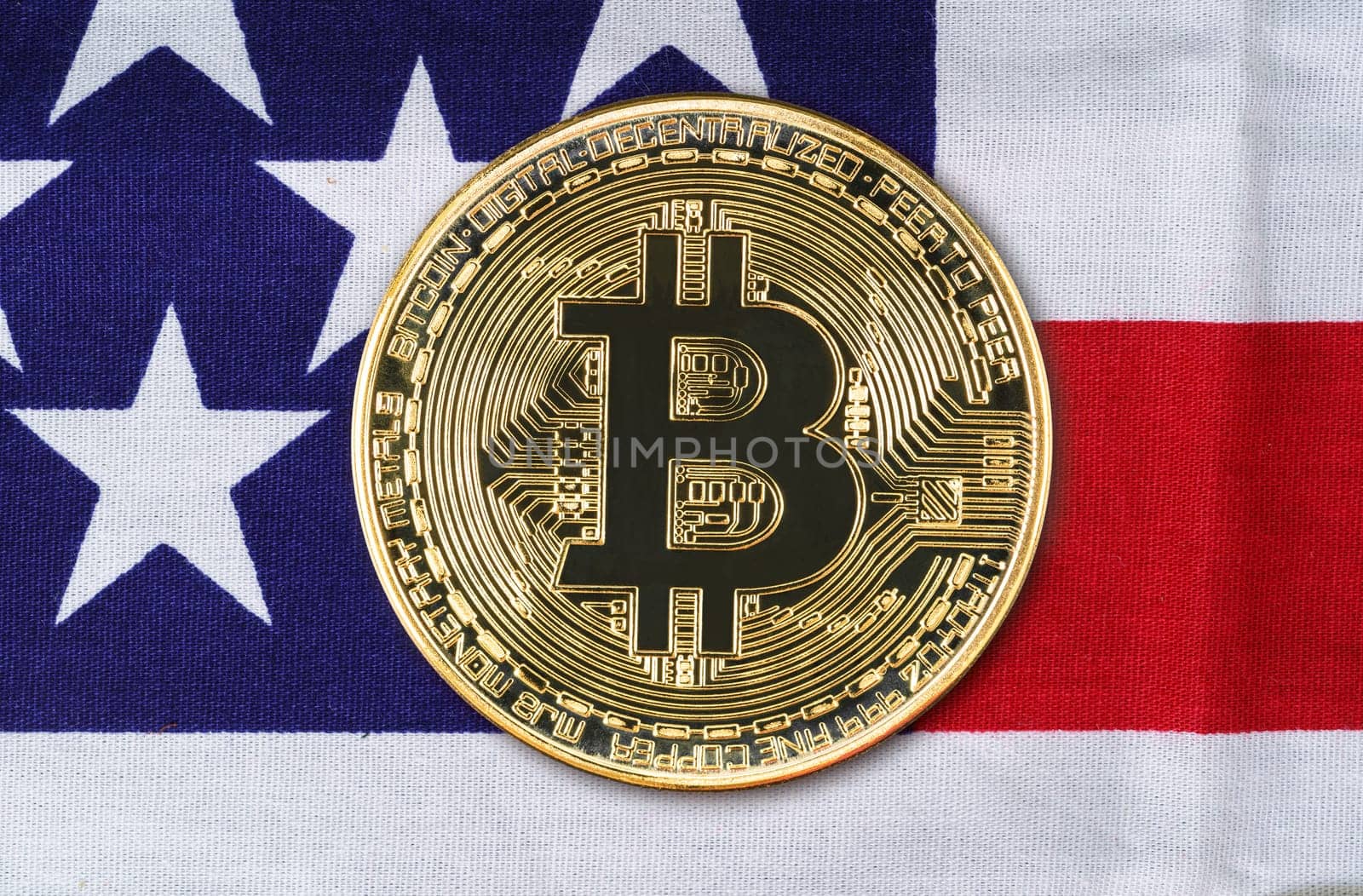 Close up Crypto currency concept. Gold Bitcoin coin on flag of United States of America USA