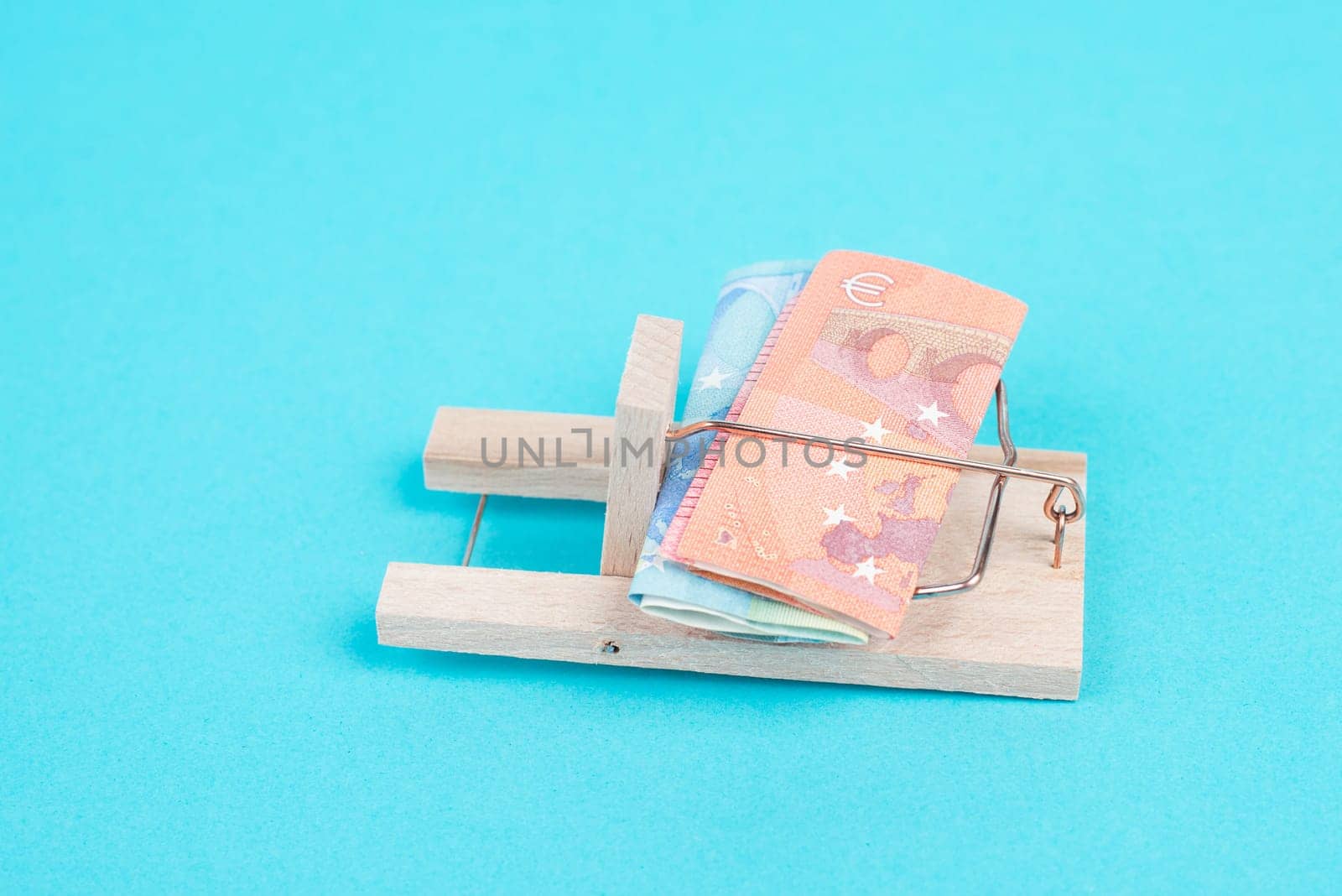 Euro banknotes in a mousetrap, bank loan, finanicial debt, inflation, risky credit and investment