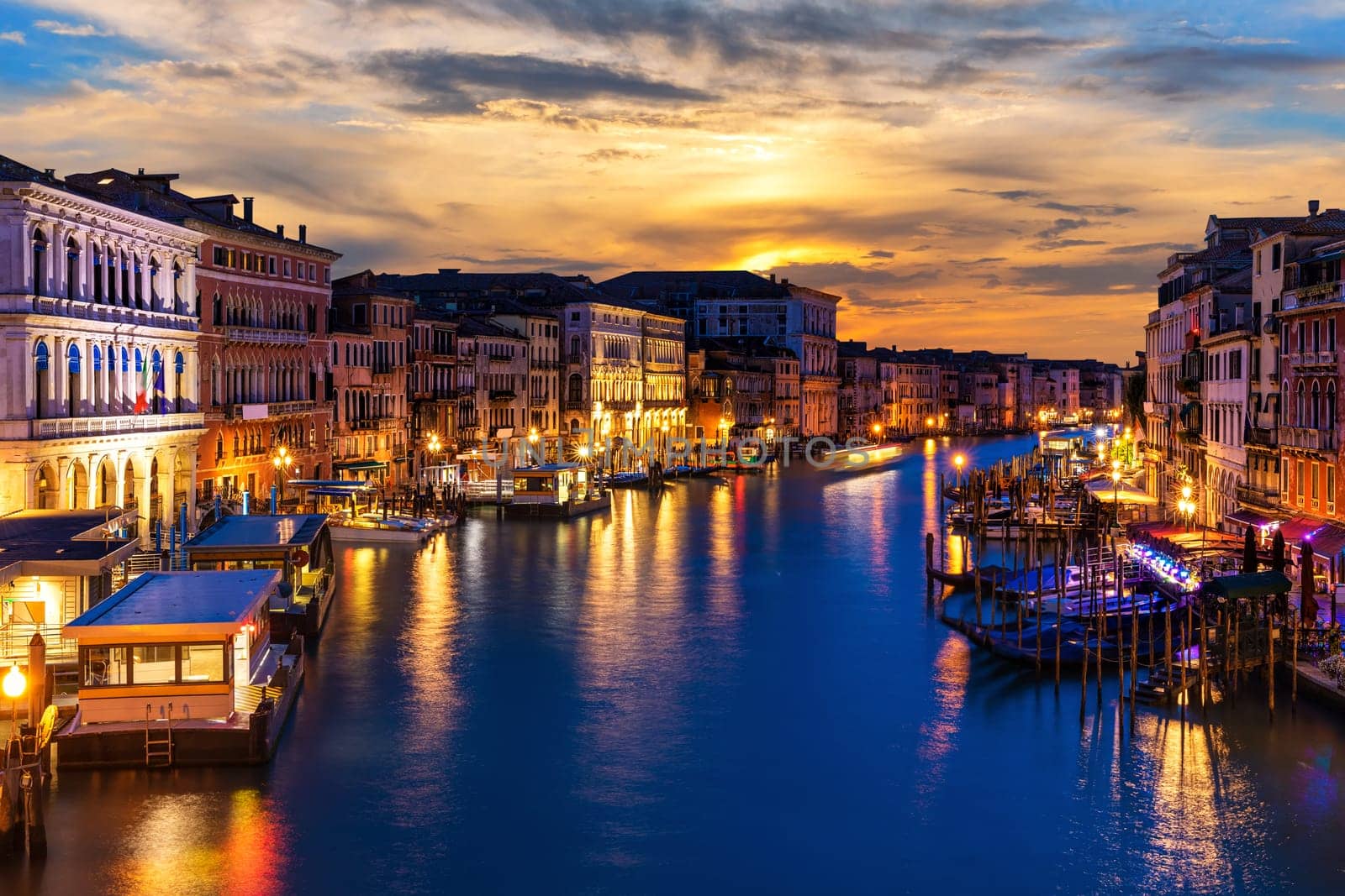 Beautiful night buildings in the Grand Canal in twilight, view from Rialto Bridge, Venice, Italy.