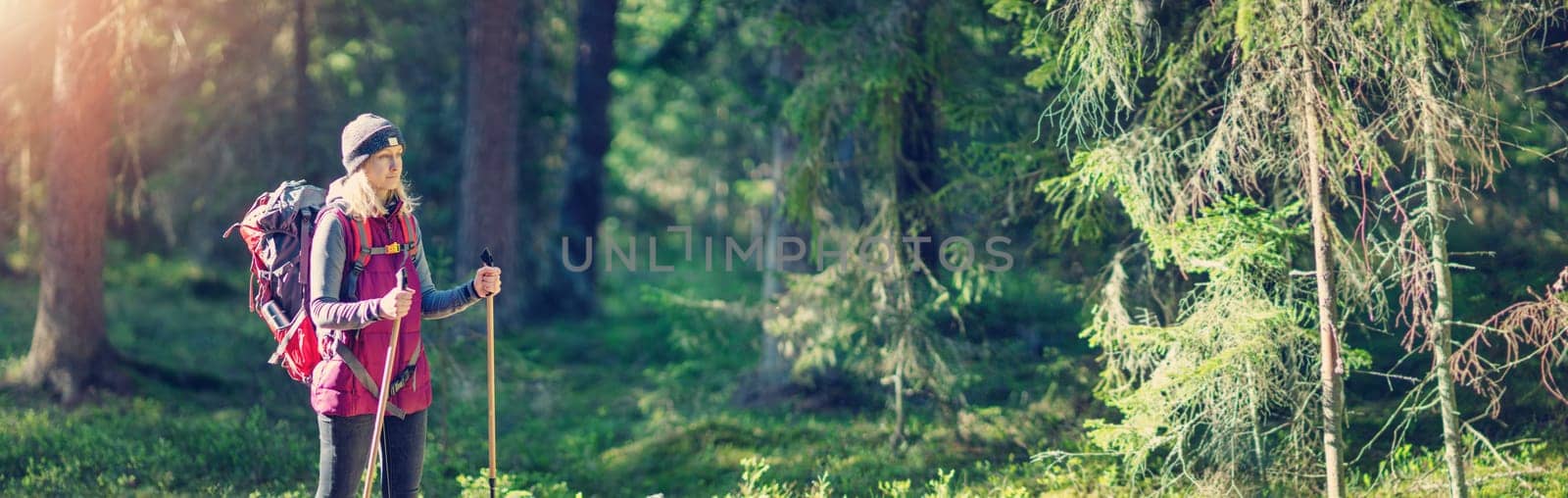 Young woman hiking and going camping in nature. Panoramic view.Concept of tourism.