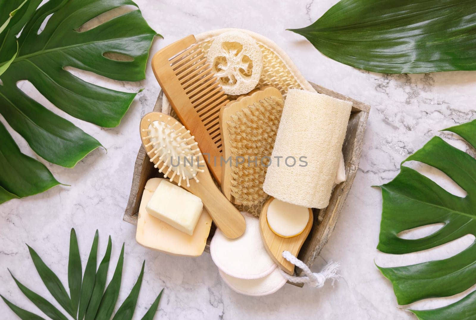 Homemade organic cosmetics and eco friendly accessories near monstera leaves flat lay, copy space. Brand packaging mockup. Natural beauty products for hair and skin care, Top view