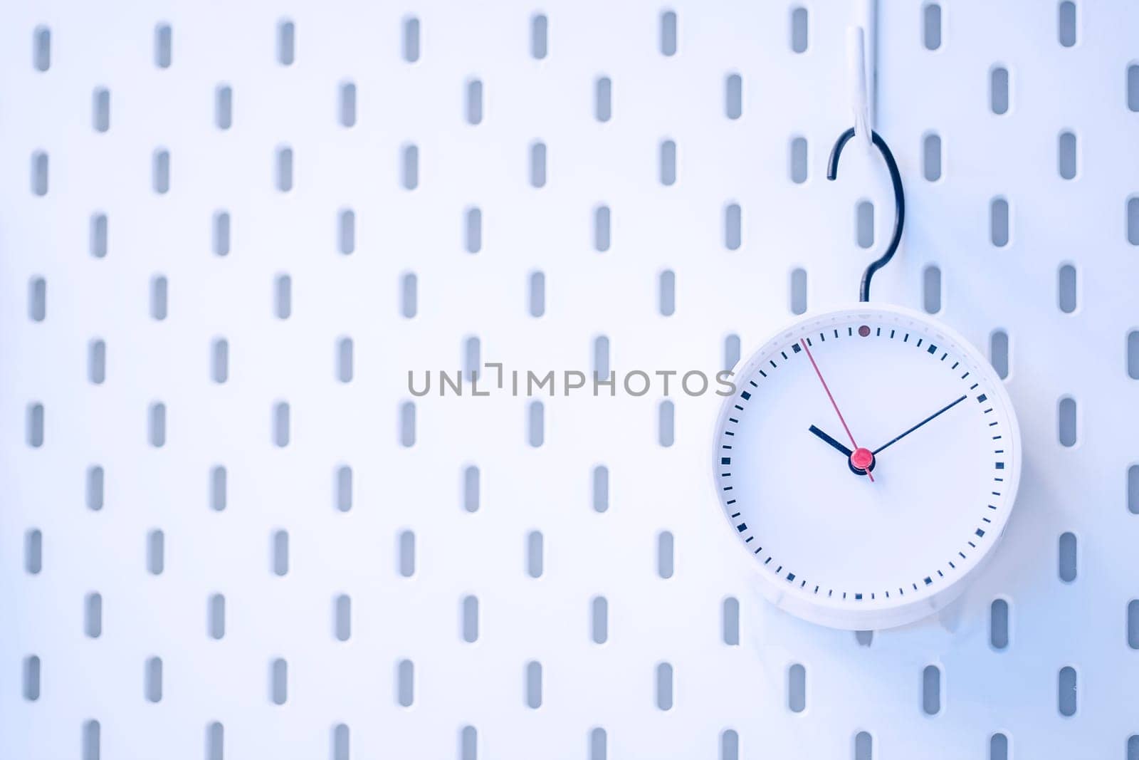 Closeup blue wall clock set on blue background
