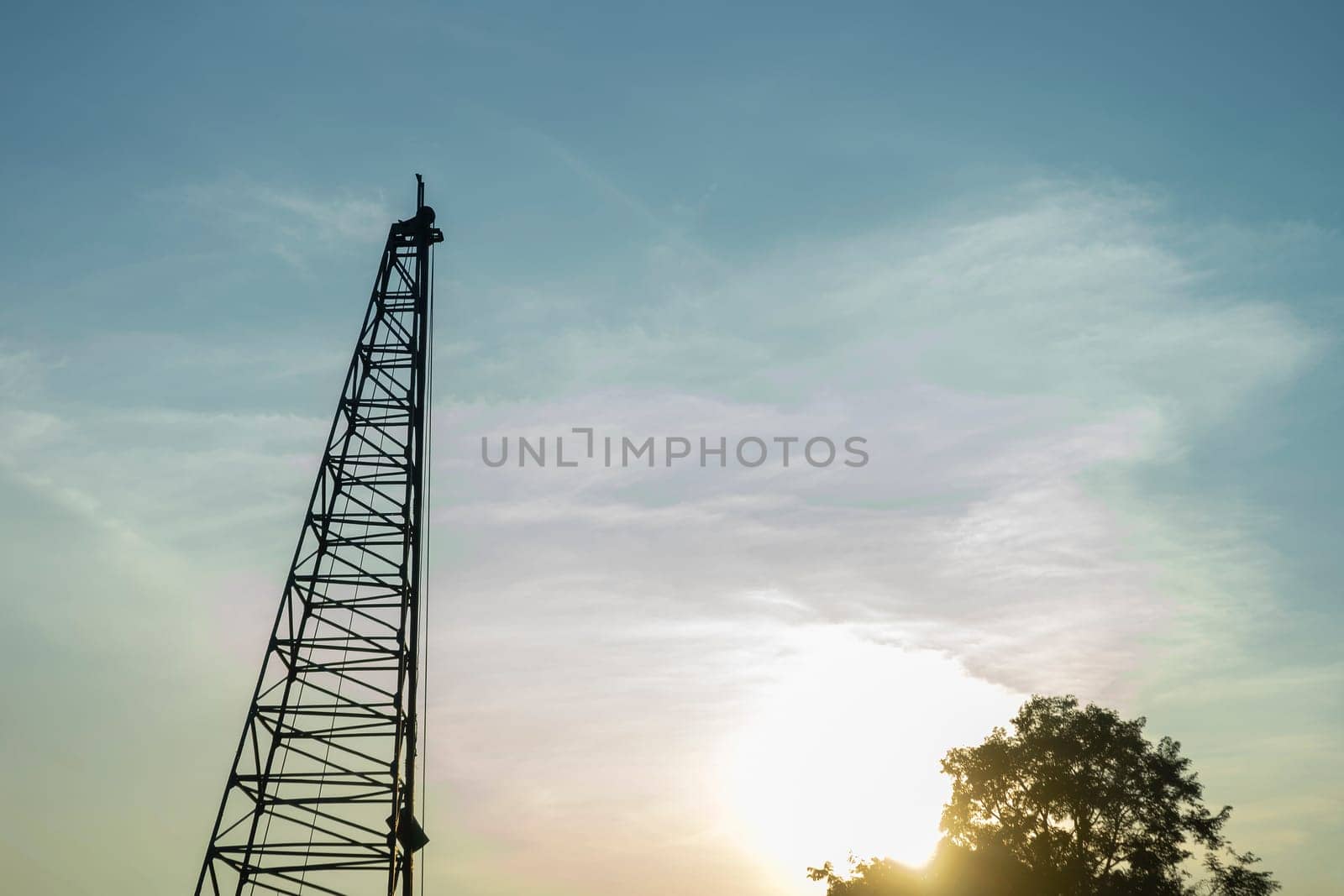 Pile driver to set precast concrete piles in evening