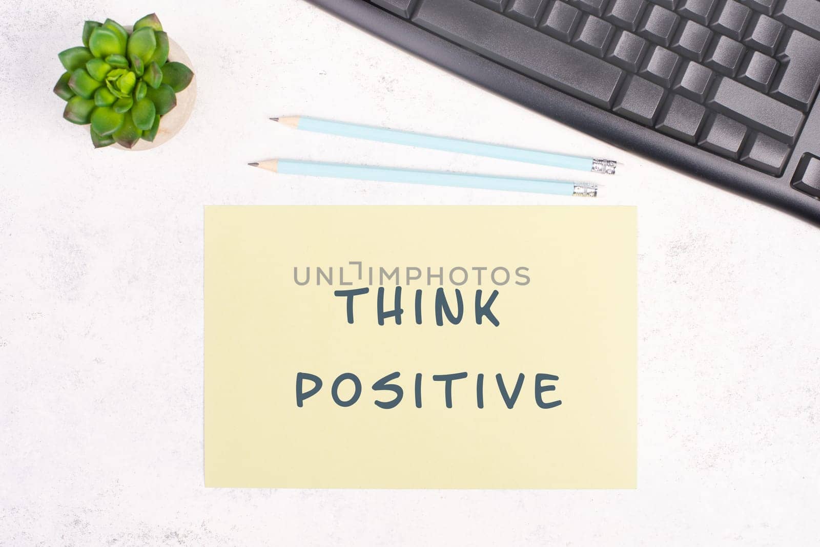 Think positive is standing on a paper, computer keyboard and a cactus, brainstorming for new ideas, new mindest, home office desk