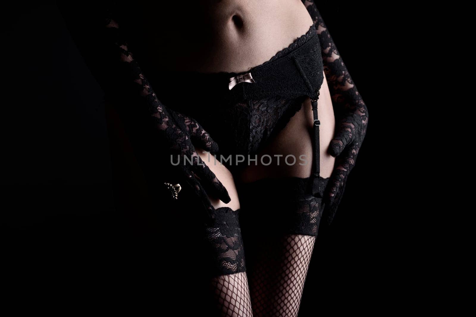 Woman in sexy black lingerie with net stockings