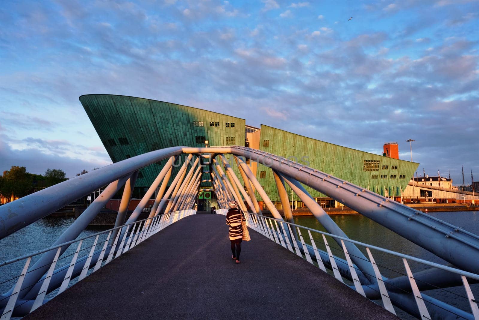 AMSTERDAM, NETHERLANDS - MAY 9, 2017: NEMO Science museum and Mr. J.J. van der Veldebrug bridge. It is the largest science center in Netherlands with over 500000 visitors per year