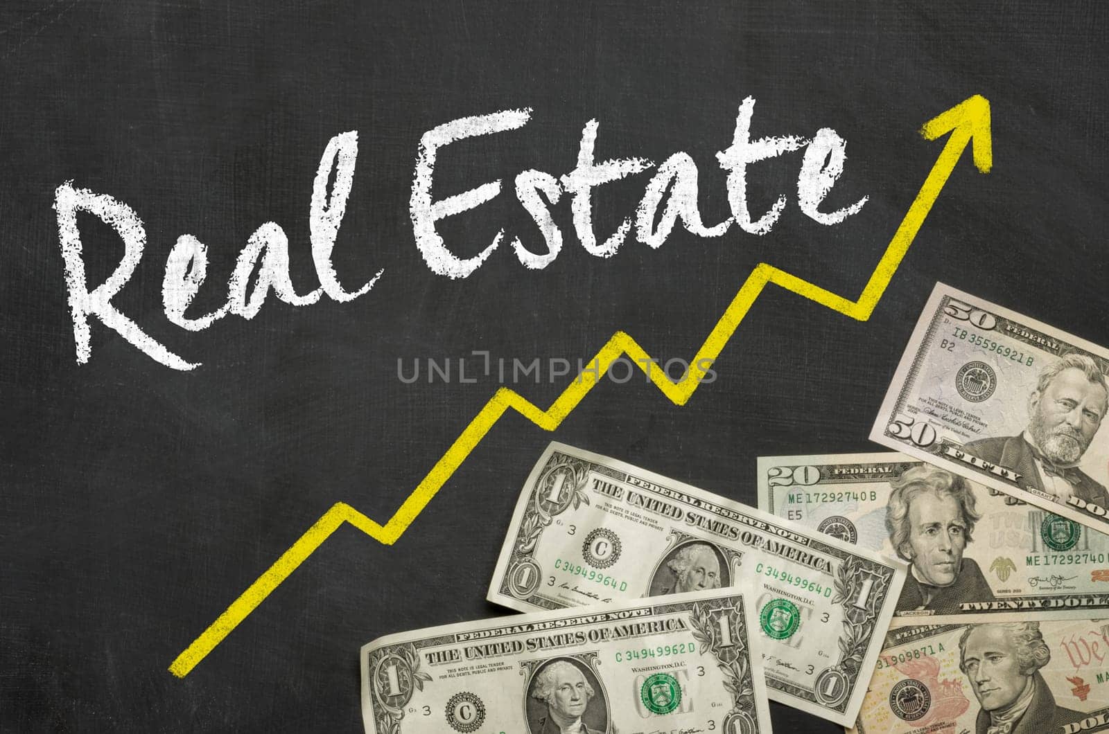Text on blackboard with Dollars - Real Estate