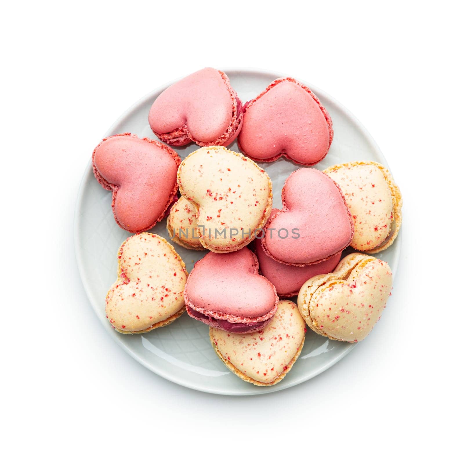 Heart shaped Sweet macarons on plate isolated on a white background.