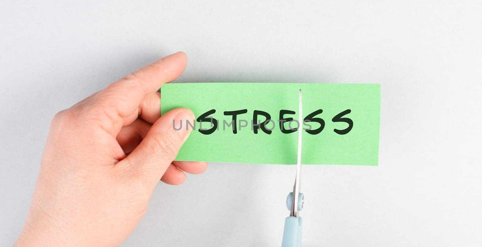The word stress is standing on a paper, cutting the word with scissors, burnout concept, work life balance, breakdown by exhaustion