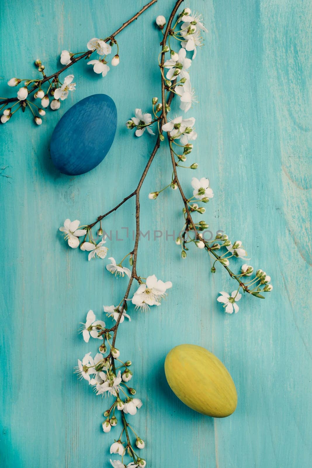 Colorful easter eggs on blue wooden table. Retro filter.