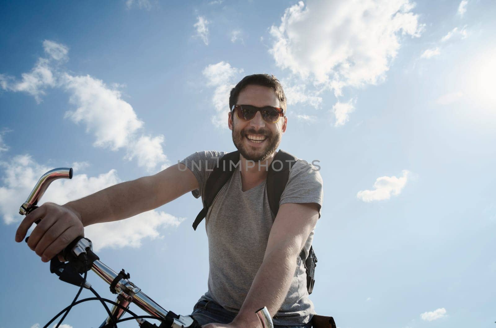 Man with bicycle having fun. Retro style image.