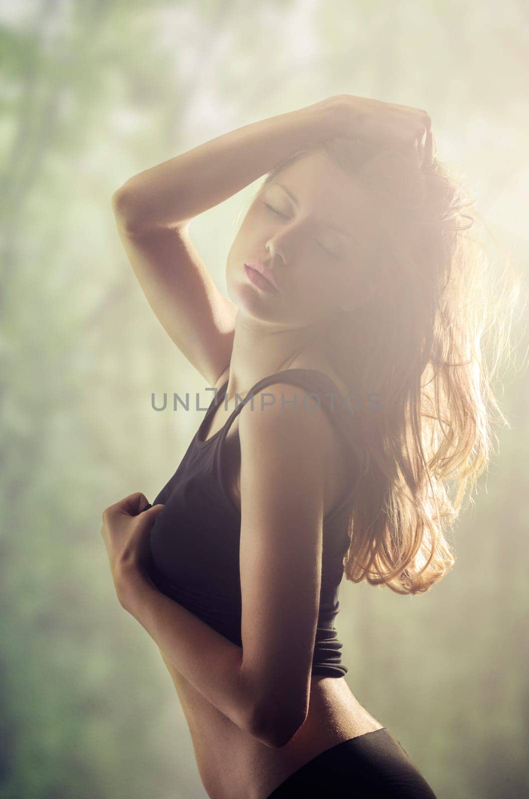 Beautiful sex woman in natural environment with sunrays in her hair.