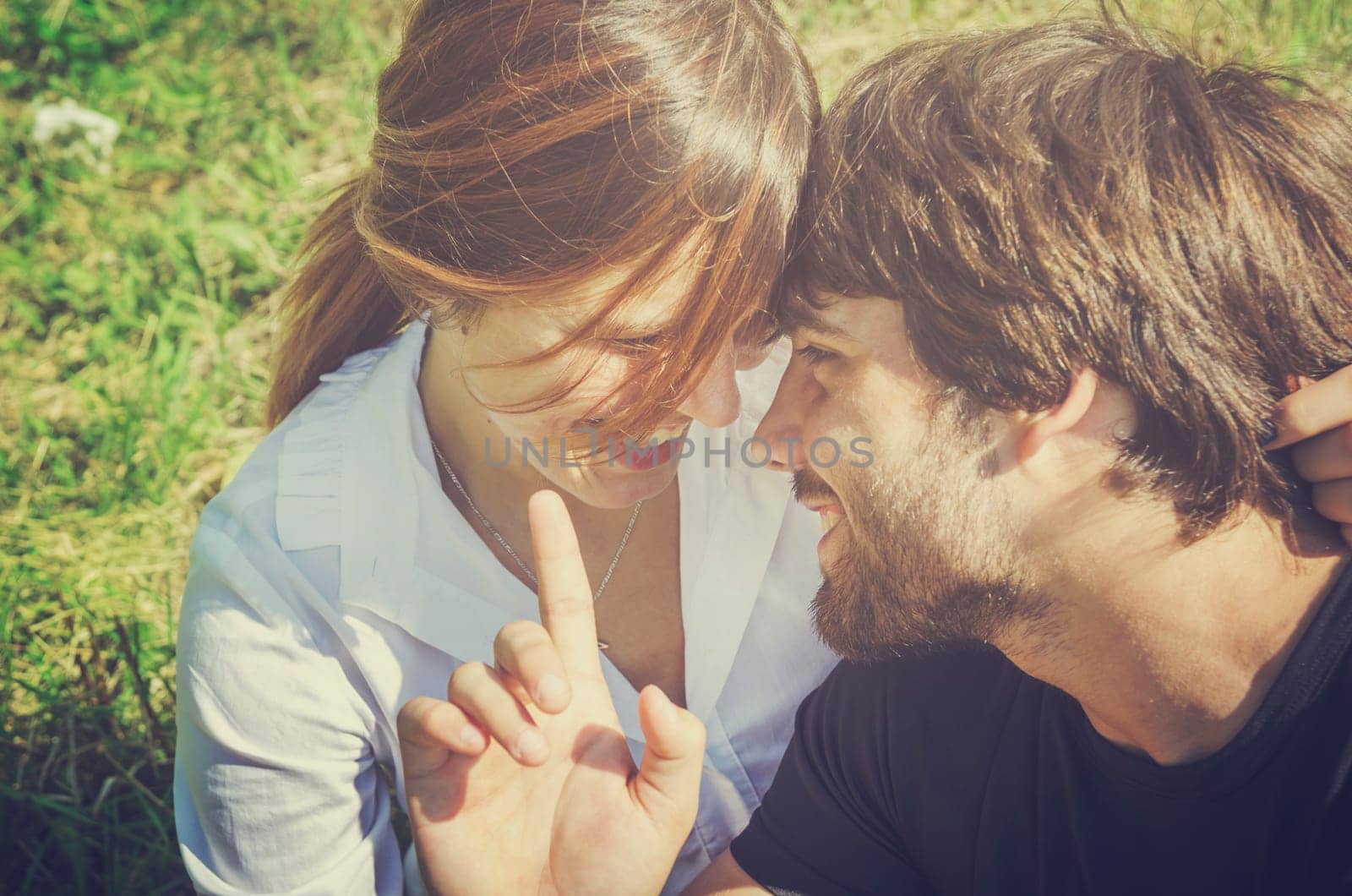 Happy young couple smiling and having fun in nature at summer holiday.